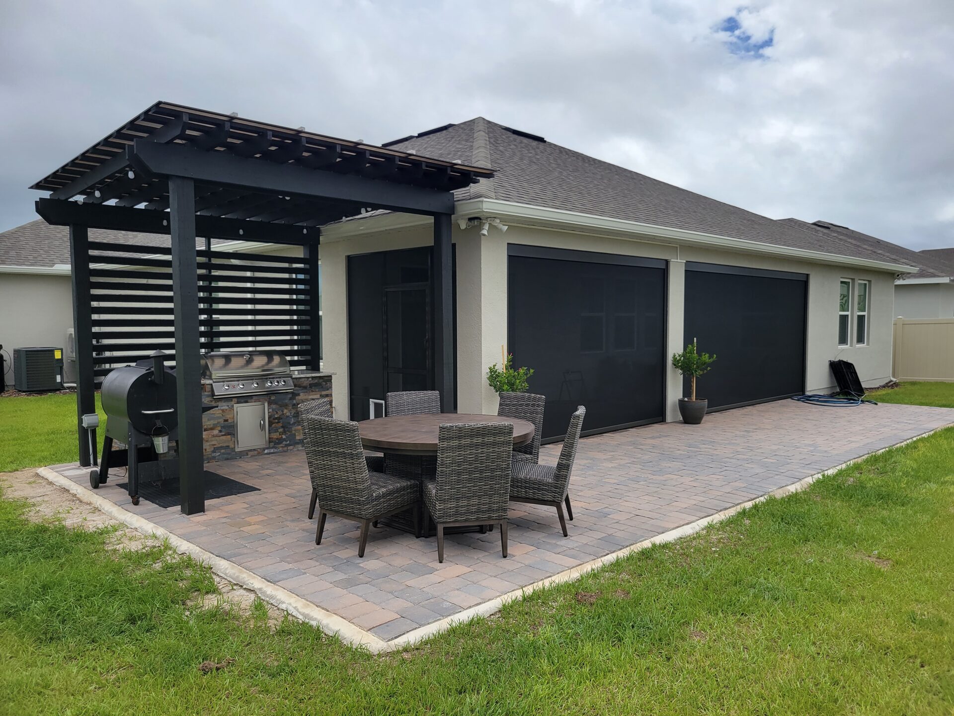 Luxury outdoor patio with retractable screens at sunset